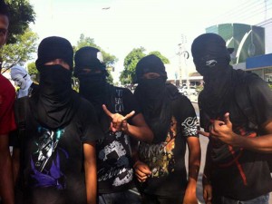 Manifestantes escondem o rosto com camisetas pretas durante protestos na Avenida Frei Serafim