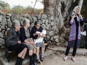 Acompanhada de duas amigas vovó amamente criança refugiada