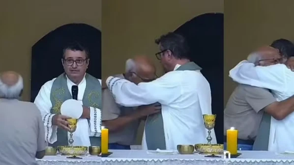 Avô busca consolo e abraça padre durante celebração religiosa